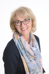 business headshot portrait of a blond woman wearing scarf against a white background